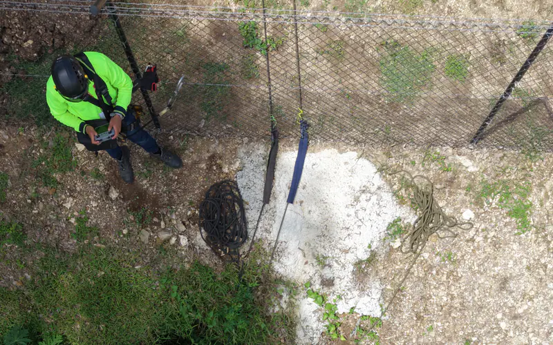 Aerial view of a technician carrying out a direct slope condition inspection