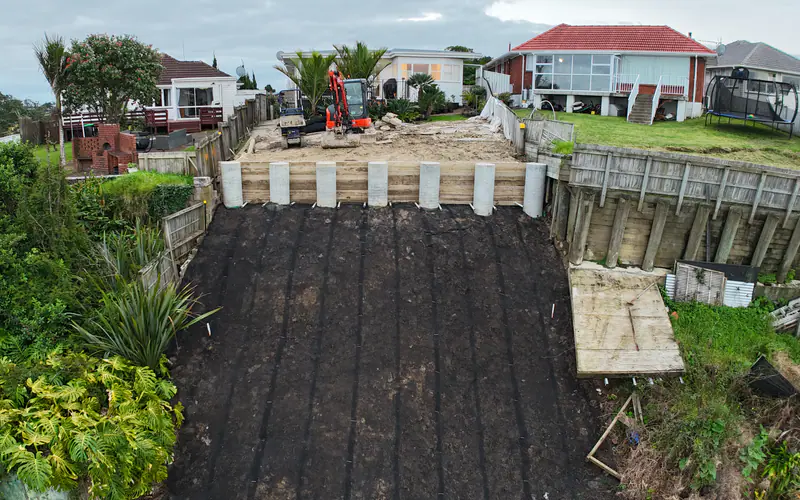 Completed reinforced residential slope with drainage and retaining elements