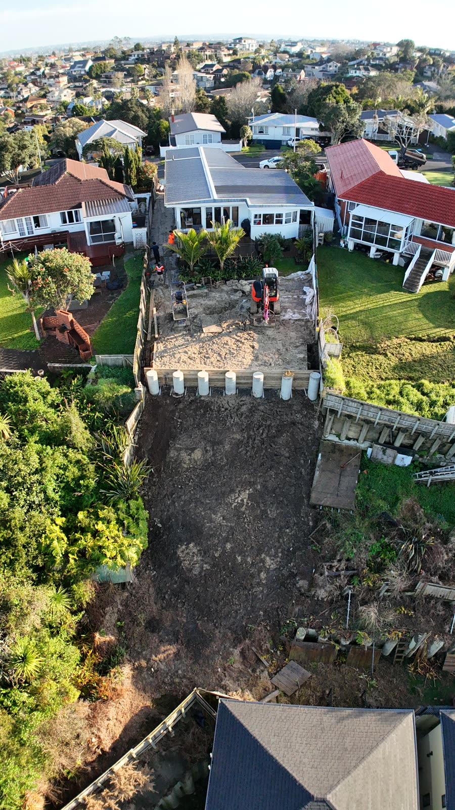 Aerial view of the slope and palisade wall during works