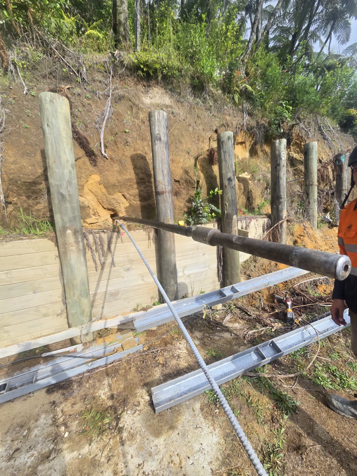Anchor installation progressing along the retaining wall line