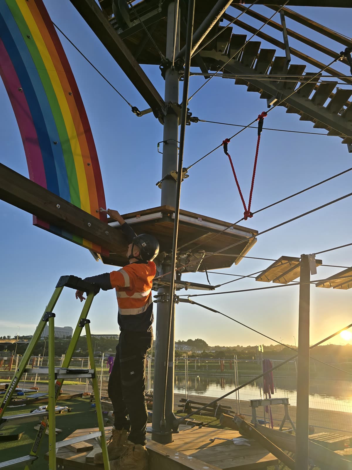 Crew securing climbing elements between steel structures